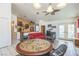 Living room area with wood flooring, ceiling fan, and adjacent dining area at 169 Alterra Dr, Henderson, NV 89074