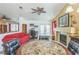 Open-concept living room features a fireplace, ceiling fan, and access to the backyard at 169 Alterra Dr, Henderson, NV 89074