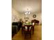 Inviting dining room featuring a wooden table, chandelier, and a decorative mirror at 1748 Jupiter Ct # C, Las Vegas, NV 89119