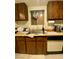 Kitchen area with light countertops, wood cabinetry, and modern appliances; an inviting space for culinary endeavors at 1748 Jupiter Ct # C, Las Vegas, NV 89119