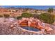 Backyard water feature with landscaped rocks and pebble groundcover sits among desert plants at 1809 Prichard Ave, Henderson, NV 89052