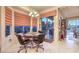 Cozy breakfast nook featuring a round table, leather chairs, and large windows with custom blinds at 1809 Prichard Ave, Henderson, NV 89052