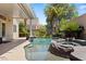 Serene backyard pool and spa area with lush greenery and a covered patio for entertaining at 2025 Dakota Lodge Ave, Las Vegas, NV 89123