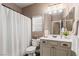 Bathroom with single sink vanity and shower with white shower curtain at 2025 Dakota Lodge Ave, Las Vegas, NV 89123