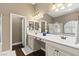 Bathroom showcasing double sinks with vanity, a mirror, and a step-in shower at 2025 Dakota Lodge Ave, Las Vegas, NV 89123