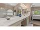 Bathroom with double sinks, vanity, a mirror, and a shower with glass door at 2025 Dakota Lodge Ave, Las Vegas, NV 89123