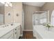 Well-appointed bathroom with a double sink vanity, separate shower, and soaking tub at 2025 Dakota Lodge Ave, Las Vegas, NV 89123