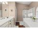Bright bathroom features double sinks with granite counters, tub, and glass shower at 2025 Dakota Lodge Ave, Las Vegas, NV 89123