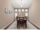 Elegant dining room with chandelier, seating for eight, and neutral decor offers a perfect space to entertain at 2025 Dakota Lodge Ave, Las Vegas, NV 89123