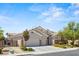 Charming home featuring a three-car garage, desert landscaping, and a secure gated entrance at 2025 Dakota Lodge Ave, Las Vegas, NV 89123