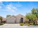 Beautiful single-Gathering home showcasing a three-car garage and delightful desert landscaping at 2025 Dakota Lodge Ave, Las Vegas, NV 89123