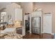 Well-equipped kitchen with stainless appliances, granite counters, and pantry access at 2025 Dakota Lodge Ave, Las Vegas, NV 89123
