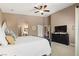 Inviting main bedroom with a ceiling fan, a TV, and an ensuite bathroom at 2025 Dakota Lodge Ave, Las Vegas, NV 89123