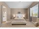 Serene main bedroom with neutral tones, and large window creating a bright and restful retreat at 2025 Dakota Lodge Ave, Las Vegas, NV 89123