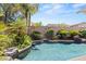 Backyard with an inviting swimming pool and lush landscape featuring rocks at 2025 Dakota Lodge Ave, Las Vegas, NV 89123