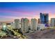 Stunning aerial view of a condo building and the vibrant city skyline at dusk at 222 Karen Ave # 3307, Las Vegas, NV 89109