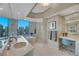 Bright bathroom with dual sinks, soaking tub, glass shower, vanity, and city views at 222 Karen Ave # 3307, Las Vegas, NV 89109