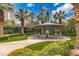 Outdoor patio area with shaded seating and a well-maintained garden at 222 Karen Ave # 3307, Las Vegas, NV 89109