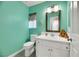 Stylish bathroom with a modern vanity, mirror, and bright turquoise colored walls, perfect for a refreshing experience at 2418 Antler Point Dr, Henderson, NV 89074