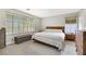 Bright bedroom with large windows, carpet, and a bench at the end of the bed at 2418 Antler Point Dr, Henderson, NV 89074