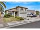 Attractive two-story home boasting a landscaped front yard, an attached two car garage, and inviting curb appeal at 2418 Antler Point Dr, Henderson, NV 89074