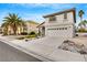 Charming two-story home featuring a two-car garage and well-maintained desert landscaping with palm trees at 2418 Antler Point Dr, Henderson, NV 89074