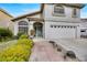 Lovely two-story home featuring a lush front lawn, a brick pathway, and an attached two car garage at 2418 Antler Point Dr, Henderson, NV 89074