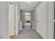 Hallway with carpet flooring and white doors and trim; arched doorway to another room at 2418 Antler Point Dr, Henderson, NV 89074