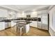 Well-lit kitchen featuring stainless steel appliances, white cabinetry, and a stylish center island with seating at 2418 Antler Point Dr, Henderson, NV 89074