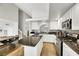 Modern kitchen with white cabinetry, dark granite countertops, and stainless steel appliances at 2418 Antler Point Dr, Henderson, NV 89074