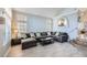 Inviting living room with large windows, tile flooring, and a comfortable sectional sofa at 2418 Antler Point Dr, Henderson, NV 89074
