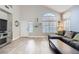 Open-concept living room features tile flooring, natural light, and neutral decor at 2418 Antler Point Dr, Henderson, NV 89074