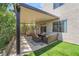 Backyard features a covered patio, lounge seating and well-kept garden at 2452 Silver Shadow Dr, Las Vegas, NV 89108