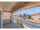 Balcony view overlooking the street with houses and palm trees, perfect for enjoying the outdoors at 2452 Silver Shadow Dr, Las Vegas, NV 89108