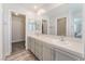 Bathroom with double sinks, large mirror and walk-in closet at 2452 Silver Shadow Dr, Las Vegas, NV 89108