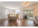 Elegant dining room featuring hardwood flooring, decorative chairs, and natural light creating a welcoming space at 2452 Silver Shadow Dr, Las Vegas, NV 89108