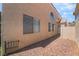 Side exterior featuring rock landscaping and neutral color scheme at 2452 Silver Shadow Dr, Las Vegas, NV 89108