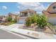 Inviting two-story home with a balcony, two-car garage, and verdant landscaping, nestled in a desirable neighborhood at 2452 Silver Shadow Dr, Las Vegas, NV 89108