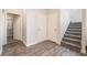View of hallway with gray wood floors, leading to carpeted stairs at 2452 Silver Shadow Dr, Las Vegas, NV 89108