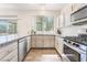 Bright kitchen featuring granite countertops, stainless steel appliances, and wood flooring at 2452 Silver Shadow Dr, Las Vegas, NV 89108