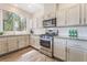 Well-lit kitchen with stainless steel appliances, granite counters and white cabinets at 2452 Silver Shadow Dr, Las Vegas, NV 89108