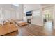 Bright living room with a fireplace, hardwood floors, and a sectional sofa creating a cozy and inviting atmosphere at 2452 Silver Shadow Dr, Las Vegas, NV 89108
