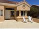 Inviting front of home featuring a cozy sitting area with two white Adirondack chairs at 2505 Showcase Dr, Las Vegas, NV 89134