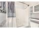 Bathroom features a shower with a decorative shower curtain and built-in storage shelves at 251 S Green Valley Pkwy # 1421, Henderson, NV 89012