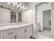 Stylish bathroom with white vanity, marble countertop, decorative mirror, and sliding barn door at 251 S Green Valley Pkwy # 1421, Henderson, NV 89012