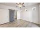 Spacious bedroom with wood-look flooring, barn door, and bright natural light at 251 S Green Valley Pkwy # 1421, Henderson, NV 89012