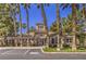 View of community clubhouse with palm trees and ample parking at 251 S Green Valley Pkwy # 1421, Henderson, NV 89012