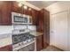 Modern kitchen featuring stainless steel appliances, granite countertops, and dark wood cabinetry at 251 S Green Valley Pkwy # 1421, Henderson, NV 89012
