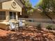 Outdoor brick patio featuring two white Adirondack chairs and an ornate white fence at 2553 Showcase Dr, Las Vegas, NV 89134