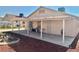 A covered patio and rock landscaping enhance this home's backyard at 2621 Blue Reef Dr, North Las Vegas, NV 89032